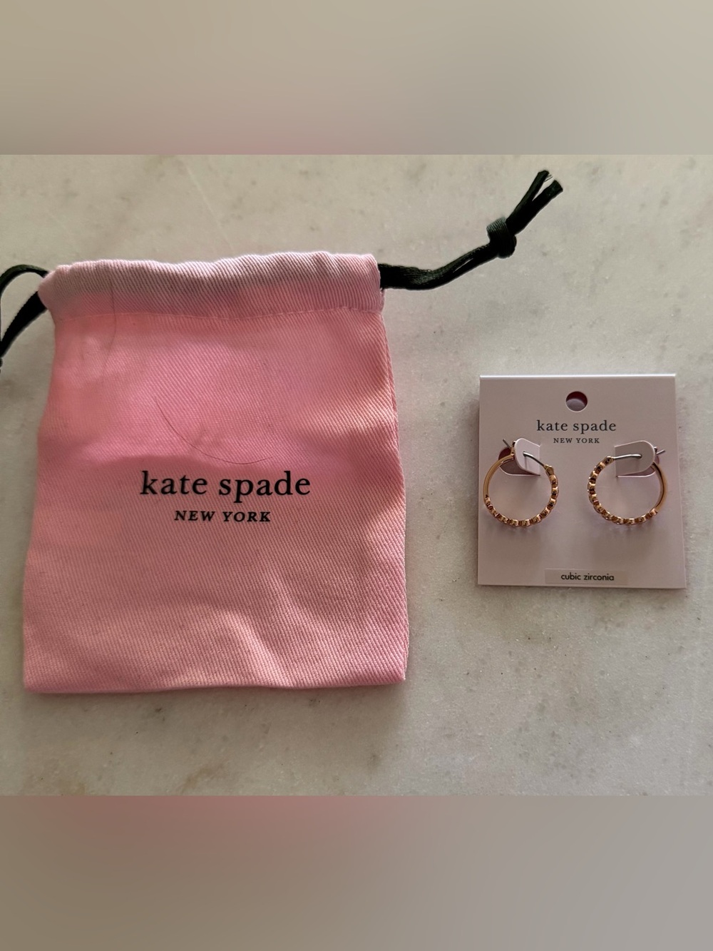 kate spade Pink Drawstring Pouch with Gold Hoop Earrings